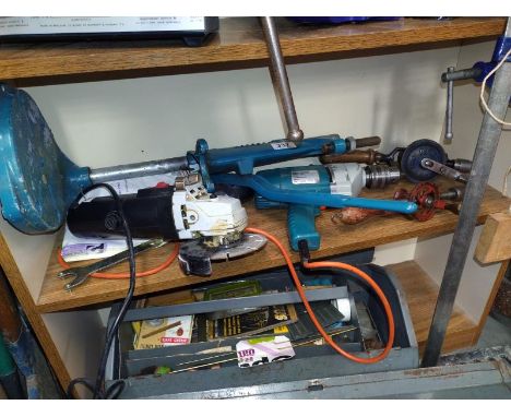 An angle grinder a hammer drill and two vintage hand drills.
