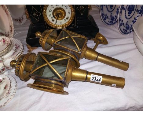 A pair of brass coach lamp style, candle lamps with one wall bracket.