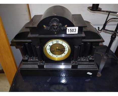 A Victorian black slate mantle clock.
