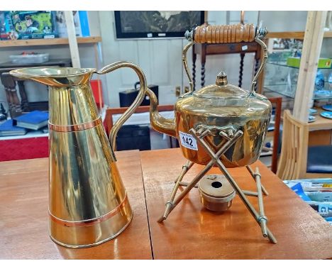 A brass kettle on stand and jug 