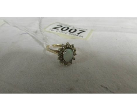 A 14ct yellow gold opal and diamond ring, size M, 2.5 grams.