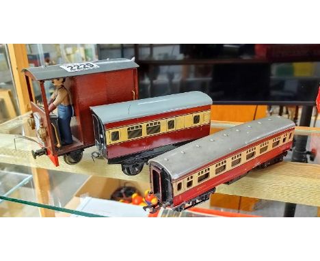 A tinplate railway carriage, a Triang railway carriage and a home built engine. 