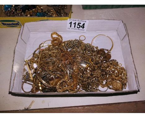 A tray of yellow metal costume jewellery