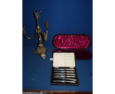 A set of silver handled knives, a case for a silver ladle and plated candelabrum.