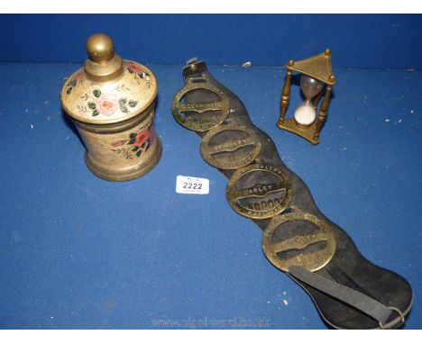 A quantity of brass including horse brasses, egg timer and brass pot with floral decoration.