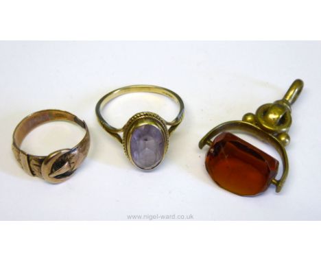 A white metal Pendant with rotating three-faceted amber rotating stone, a yellow metal buckle and belt style Ring marked KBSA