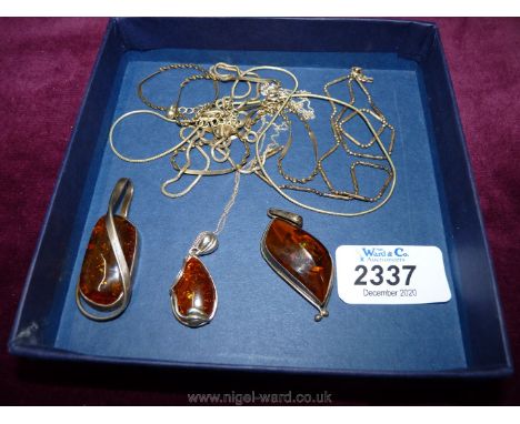 Five silver chains with three amber pendants with silver surround.