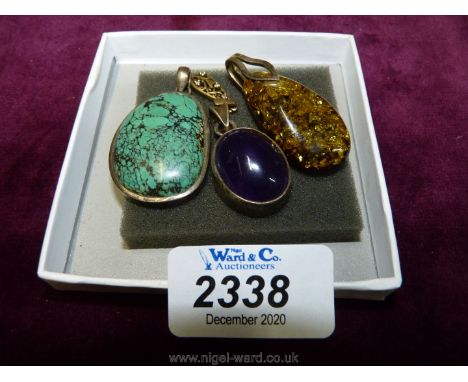 Three pendants, one with turquoise stone, one with a purple stone and one with a yellow stone all encased with a silver band 