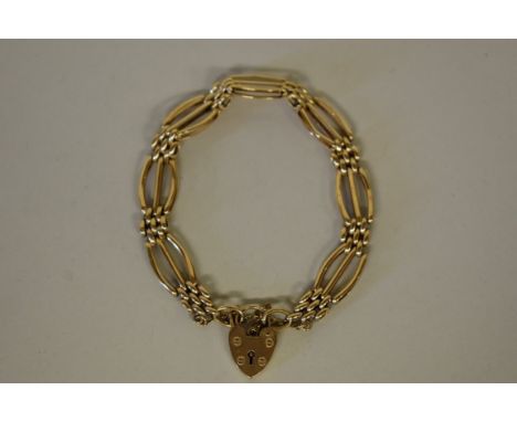 A fancy gold gate bracelet, the padlock clasp hallmarked 375, 14.5g. 