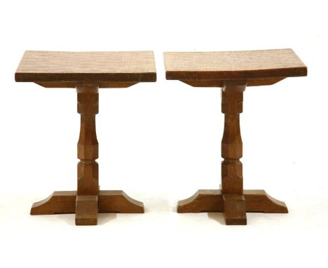 A pair of Mouseman style oak lamp tables, the square tops on facetted column and ‘X’ form base