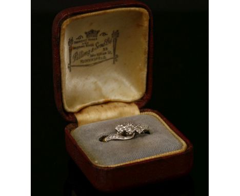 A gold three stone diamond ring, stamped 18ct PLAT, size K½, 2.67g