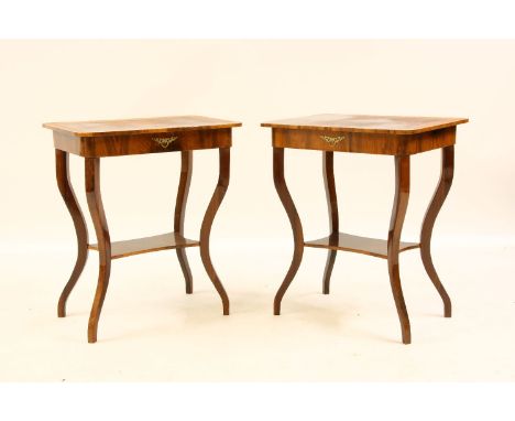 A pair of walnut lamp tables, the crossbanded rectangular tops on slender cabriole supports, united by undertier