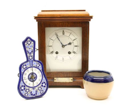 An early 20th century walnut mantel clock, eight day movement marked Lenzkirch, height 27.5cm, together with an enamelled pot