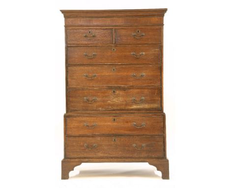 An 18th century oak tallboy, the upper section with two short and three long drawers, the base with two long drawers on brack