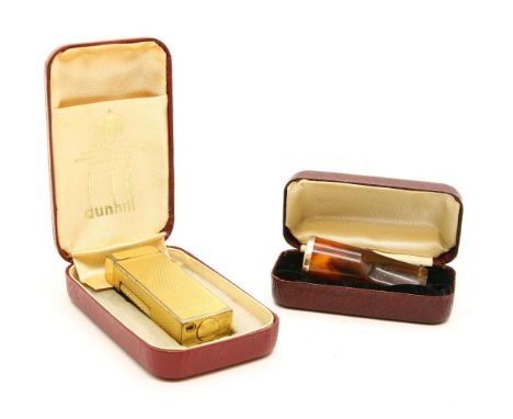 A Dunhill gold plated lighter, together with a gold mounted and ember cigar holder