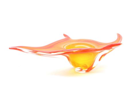 A Czech mid century glass bowl, of swirling, sinuous form and orange colour, 60cm long and 33cm wide