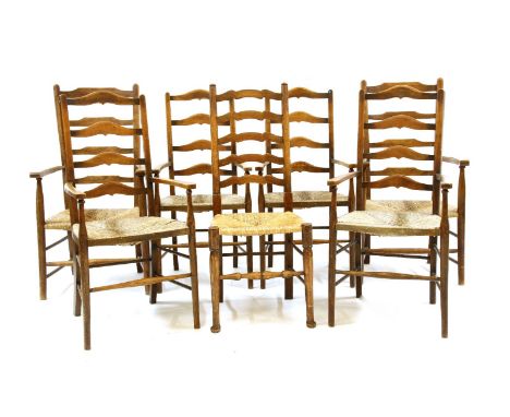 A harlequin set of 19th century rush seated ladder back elbow chairs, on stretchered turned supports, together with a similar