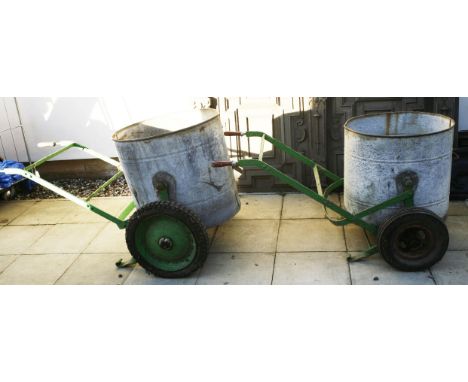 Two vintage galvanised bodgers with green painted wrought iron trollies, 70cm wide, 56cm deep, 64cm high and 62cm wide, 53cm 