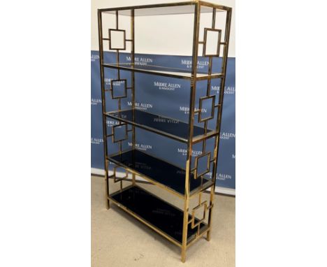 A 1970's/80's Italian designed lacquered brass framed and black glass five tier étagère or shelf unit in the style of Romeo R