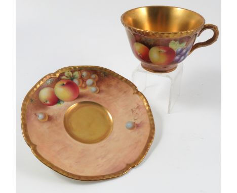 A Royal Worcester tea cup and saucer, decorated with hand painted fruit by Leaman and Roberts Condition report: Good conditio