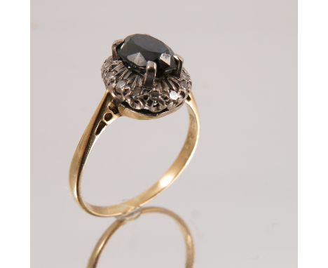 A diamond and sapphire cluster ring, stamped '18ct Plat', the oval cut enclosed by single cuts, finger size O, 2.5g gross