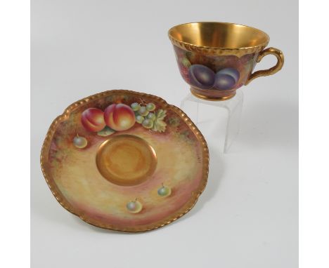 A Royal Worcester tea cup and saucer, decorated with hand painted fruit by Leaman Condition report: Good condition