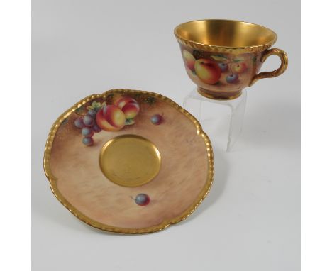 A Royal Worcester tea cup and saucer, decorated with hand painted fruit by Roberts Condition report: Good condition