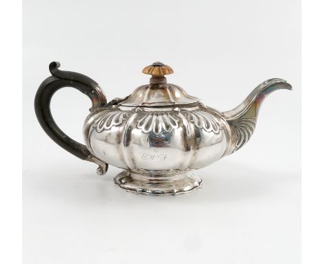 A silver teapot, a squat lobed form, decorated with shells, engraved with initials, London 1826, weight 12oz all in