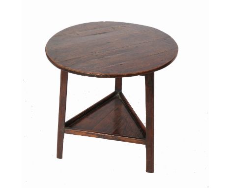 A 19th century oak cricket table, with a galleried shelf under, diameter 26ins Condition report: Height 28.25ins. The top has