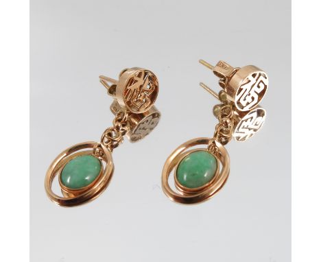 A pair of jade drop earrings, the oval shallow cabochon suspended from character pierced fittings