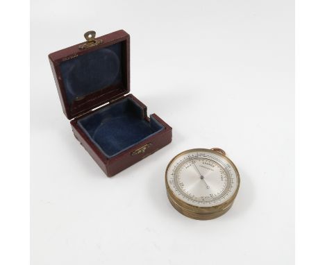 A gilt metal cased barometer, with silvered dial marked Compensated, in a leather covered square case