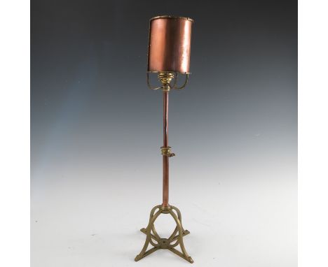 A Birmingham Guild of Handicraft copper and brass table lamp, with curved copper reflector, the flower bud light holder now m