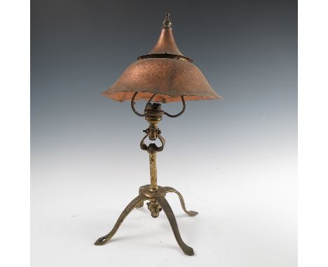 A Birmingham Guild of Handicraft copper and brass table/reading lamp, the copper double domed shade supported on three arms, 