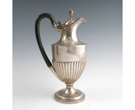 A silver hot water jug, with urn finial, gadrooned lower body, raised on a circular pedestal foot, London 1899, weight 14oz a