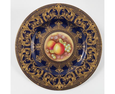 A Royal Worcester plate, decorated with apples and grapes by Brian Leaman to a deep blue and gilt border, diameter 10.75ins C