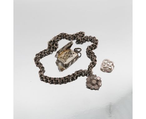 A Victorian silver vinaigrette, of shaped rectangular form with engine turned decoration, the pierced grill decorated with sc