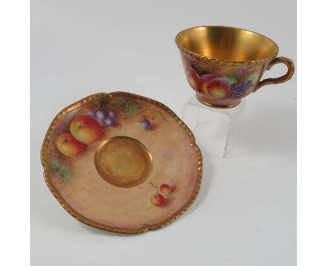 A Royal Worcester tea cup and saucer, decorated with hand painted fruit by Leaman Condition report: Minor scratch to saucer, 