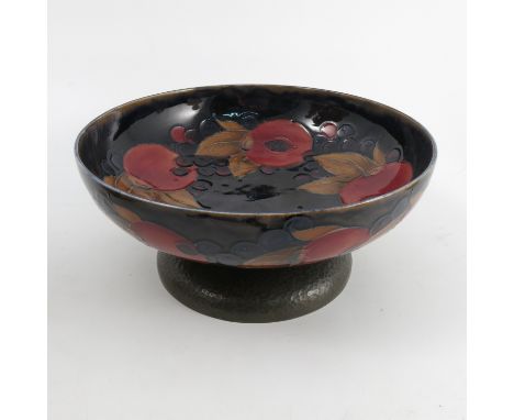 A Moorcroft pottery bowl, decorated in the Pomegranate pattern, raised on a hammered pewter covered base, diameter 9.5ins Con