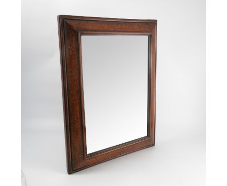 A 19th century mahogany cushion framed wall mirror, decorated with scrolls, plate size 17.5ins x 12.25ins