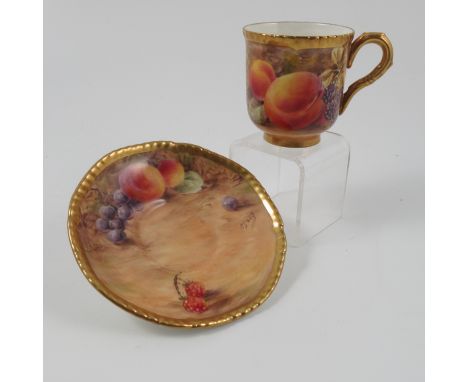 A Royal Worcester coffee cup and saucer, decorated with fruit by Love, circa 1954 Condition report: Good condition