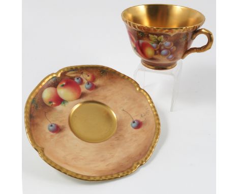 A Royal Worcester tea cup and saucer, decorated with hand painted fruit by Roberts Condition report: Good condition