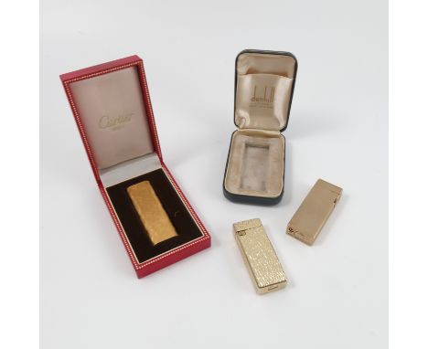 A boxed 9ct gold cased Dunhill cigarette lighter, the rectangular case with engine turned decoration, height 2/75ins, togethe