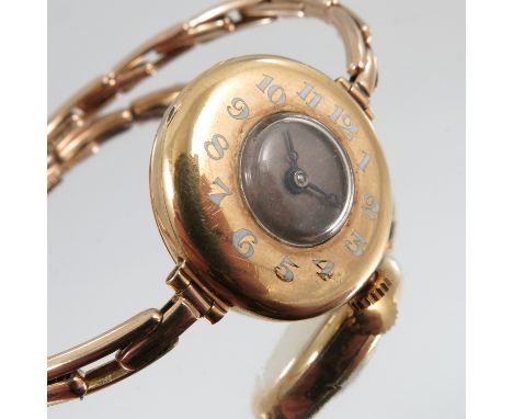 Rolex, a lady's 18 carat gold mechanical wrist watch, in a half hunter style case, with enamel numerals to the bezel, London 