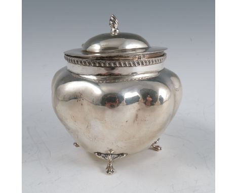 A silver tea caddy, with oval hinged lid, having a gadrooned edge to the shaped oval body, raised on four scroll legs, Birmin