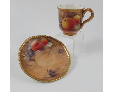 A Royal Worcester coffee cup and saucer, decorated with fruit by Love, circa 1954/5 Condition report: Very minor scratch to c