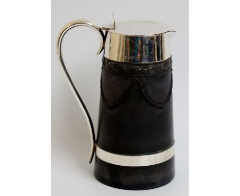 A Wedgwood silver mounted black basalt lidded jug with silver collar, lid, loop handle and girdle, the black basalt body with