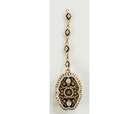 An unusual gold, white and black enamel vinaigrette of shaped oval design decorated with central wheel, leafage and palmettes