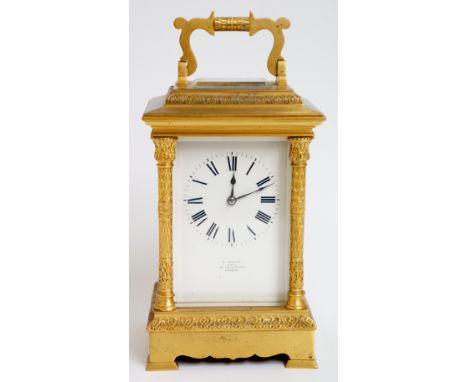 A 19th Century mammoth ormolu cased carriage clock with folding bale centred handle, four bevelled glass panels the white fac