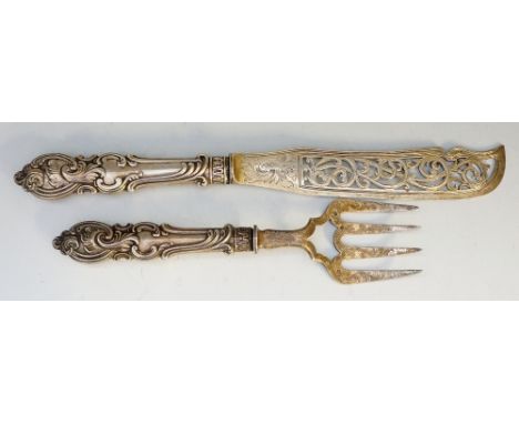 A pair of Victorian silver fish servers, the tine and blade engraved with stylised geometric and floral patterns, the handles