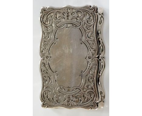 A mid Victorian shaped rectangular silver snuff box, the hinged lid with vacant cartouche surrounded by trailing leafage the 